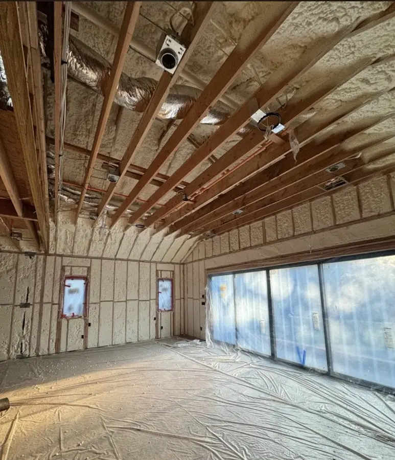 Interior walls and ceiling insulated with spray foam during new construction in Iroquois Point